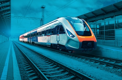 A train pulls into a station to collect waiting passengers